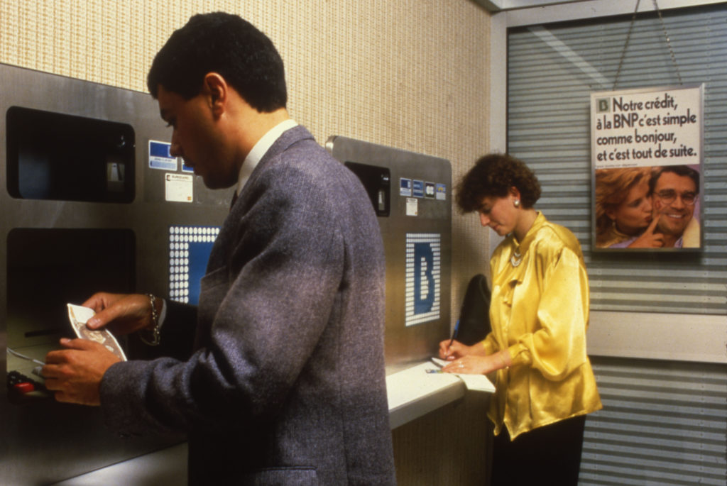 Customers of the BNP conducting financial transactions on an ATM, BNP Paribas Historical Collections