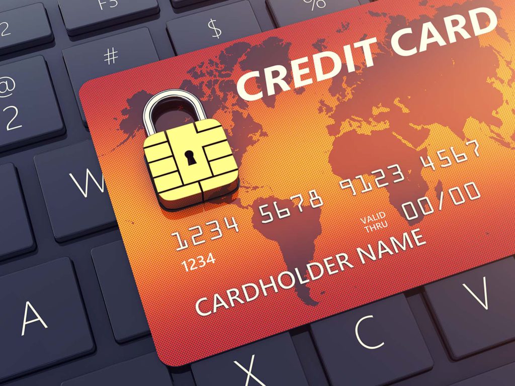 Credit card with security chip as padlock on a computer keyboard